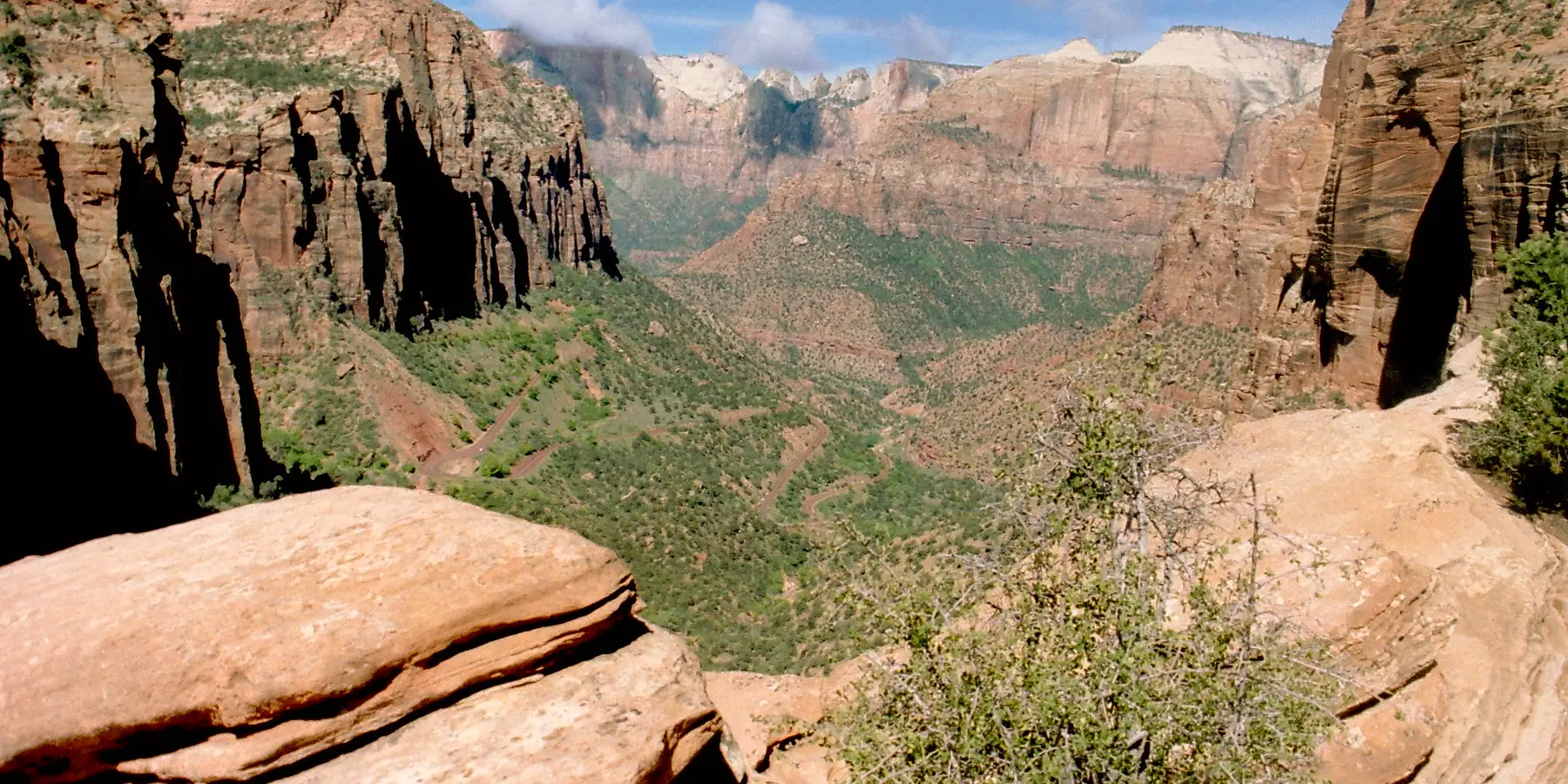 Sandstone ledges in the foreground and the canyon below from Canyon Overlook, Zion National Park.