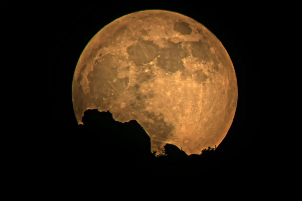 A close view of the full moon rising, photographed in Zion National Park.