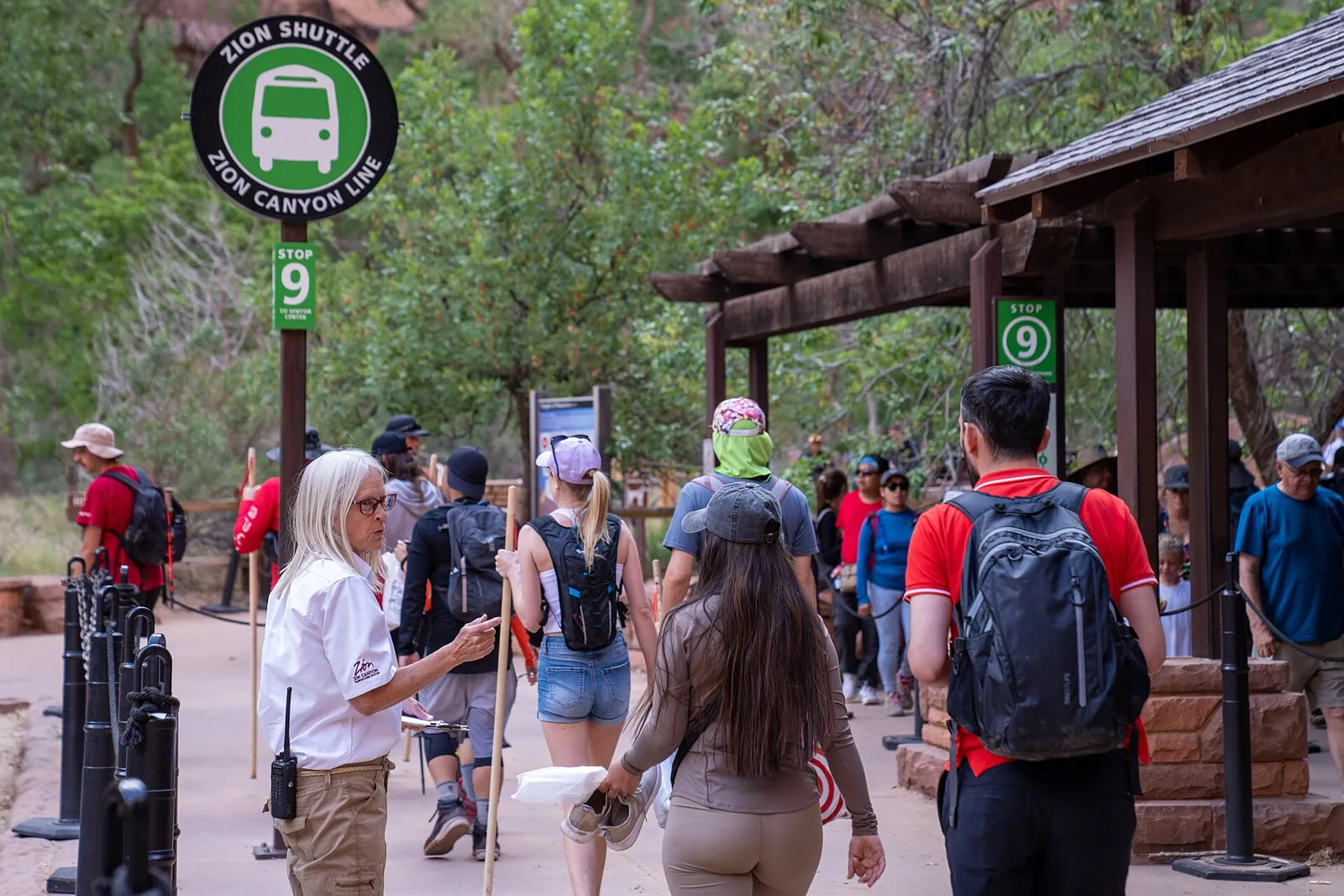 Visitors lining up to board the park shuttle at the Temple of Sinawava stop in Zion National Park.